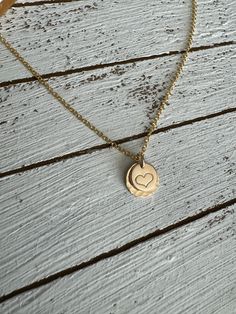 The sweetest necklace ever….featuring a hand stamped heart set on a larger stamped disc and a dainty chain, this little beauty goes with everything! Material is 14k gold filled. Chain measures 16” Handmade at the time you order. Dainty 14k Gold Filled Engraved Charm Necklaces, Dainty Hand Stamped Charm Necklaces For Everyday, Dainty Hand Stamped Charm Necklace For Everyday, Dainty Engraved 14k Gold Filled Charm Necklaces, Dainty 14k Gold Filled Engraved Charm Necklace, Dainty Hand Stamped 14k Gold Charm Necklaces, Mother's Day 14k Gold Filled Round Pendant Charm Necklace, Dainty Hand Stamped 14k Gold Necklace, Dainty Stamped Charm Necklaces For Everyday