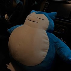 a blue and white stuffed animal sitting in the driver's seat