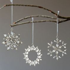 three snowflakes hanging from a tree branch