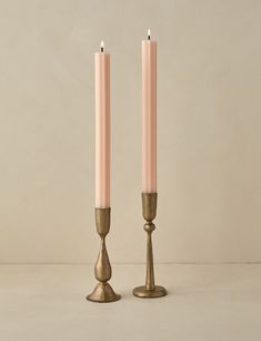 two candles are standing next to each other