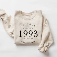 a white sweatshirt with the words vintage since 1939 printed on it, sitting on a white surface