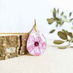 This Cherry blossom necklace is part of my cherry blossom jewelry collection. The sakura flower is highly admired in Japan, so take this sakura flower necklace with you to wear a little piece of this magic beauty. This real flower necklace will never make you go unnoticed because it is really elegant and unique. A cherry blossom necklace to have the Spring always with you... The chain is made of hypoallergenic stainless steel. The resin provides this cherry blossom necklace a perfect crystalline Feminine Flower Pendant Necklace Gift For Her, Feminine Flower Pendant Necklace As Gift For Her, Feminine Flower Pendant Necklace As A Gift, Feminine Necklace With Flower Pendant For Her, Feminine Necklace With Flower Pendant As Gift For Her, Delicate Flower Necklace For Her, Delicate Flower Pendant Necklace As Gift For Her, Feminine Flower-shaped Necklaces For Gifts, Dainty Blossom Flower Jewelry