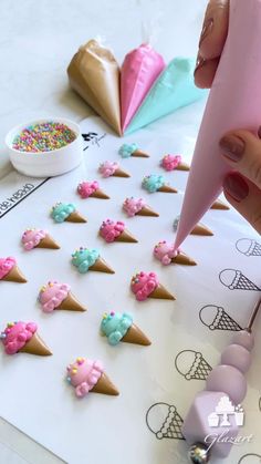 someone is making ice cream cones out of doughnuts and sprinkles