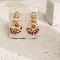 Description: Spark your traditional style with these regal silver dangle earrings from Paksha. Featuring a dazzling moissanite stone on the stud along with CZ intricate, layered with moissanite studded jhumki and chandbali layers. This pair is finished with gold-tone plating and little pearl & ruby bead drops. Wear yours with other moissanite jewelry – these are true favorites. Product Information Materials used: 925 Silver with 1.0-microns Yellow Gold Plating Stones: Semi precious stones Length Diwali Temple Jewelry Earrings With Elegant Design, Traditional Bridal Earrings With Elegant Design For Festivals, Traditional Bridal Earrings With Elegant Design, Diwali Elegant Temple Jewelry Earrings, Traditional Elegant Bridal Earrings For Festivals, Festive Elegant Design Chandelier Earrings, Festival Chandbali Earrings In Cubic Zirconia, Festive Chandbali Cubic Zirconia Jewelry, Traditional Chandbali Bridal Earrings With Elegant Design