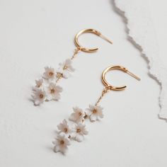 Classic gold hoop earrings accented with a cluster of hanging ivory florets. Dainty and whimsical, these romantic bridal earrings feature handmade polymer flowers. Assembled by hand in Los Angeles. White 14k Gold Filled Bridal Earrings For Wedding, Delicate Flower Hoop Earrings For Weddings, 14k Gold Filled White Bridal Earrings For Wedding, Delicate Small Hoop White Earrings, Delicate White 14k Gold Filled Earrings, Dainty Aesthetics, 14k Gold Filled Hoop Earrings For Wedding, White 14k Gold Filled Earrings For Weddings, Wedding White 14k Gold Filled Hoop Earrings