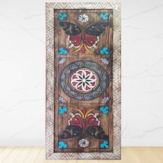 an ornate wooden panel with colorful designs on it