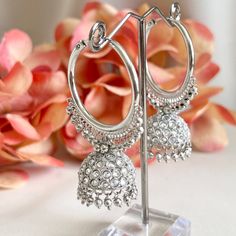 "These silver-plated polki chandbali jhumka hoop earrings are a stunning addition to any outfit. The intricate detailing and beautiful silver beads add an elegant touch to this Bollywood inspired piece, while polki stones give it a gorgeous glimmering sparkle. Length 2.3\" | Width 1.5\" Items are carefully packed and ready for gifting. All pictures are taken in natural light please allow for slight variations in color due to camera settings. Jewelry Care ✨Protect your jewelry in a closed box or pouch   ✨Wear jewelry after you have applied lotion or perfume ✨Gently buff with a soft cotton cloth  Visit our website: www.desimoon.etsy.com Thank you for visiting and hope you enjoy my shop!" Festive Metal Hoop Earrings In Temple Jewelry Style, Bridal Earrings For Diwali, Silver Hoop Jewelry For Celebration, Chandbali Hoop Earrings With Latkans, Silver Bollywood Hoop Earrings With Intricate Design, Silver Metal Hoop Earrings For Celebrations, Heavy Temple Jewelry Hoop Earrings, Silver Temple Jewelry Style Hoop Earrings For Celebrations, Silver Temple Jewelry Hoop Earrings For Celebration