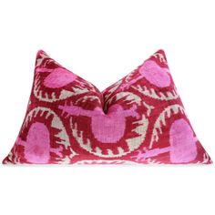 a pink and white pillow with hearts on it's side, against a white background