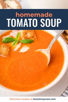 a bowl of tomato soup with bread on the side