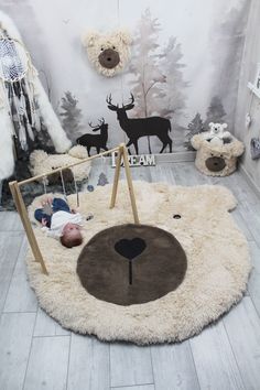 a baby is sleeping in a room with deer decorations