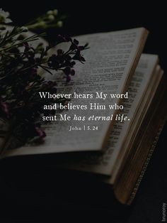 an open book with flowers on top of it and the words, whoever hears my word and believes him who sent me has eternal life