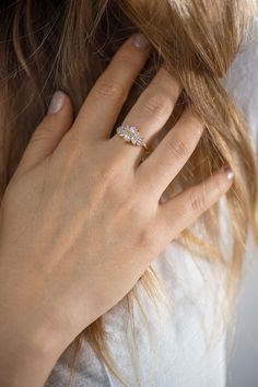 a woman's hand with a diamond ring on her finger