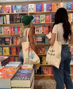 two women are looking at books in a bookstore