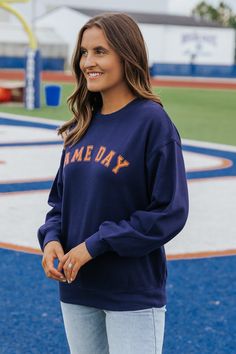 This game day sweatshirt is an essential for game days and everyday wear! Stay warm and stylish in our Navy Game day Graphic Sweatshirt! Made with 100% soft cotton, this long sleeve sweatshirt features a round neckline and ribbed cuffs for a comfortable fit. Simply style it with your favorite denim wear and sneakers to complete the look! Collegiate Sweater For Game Day, Collegiate Long Sleeve Sweater For Game Day, Collegiate Team-colored Sweatshirt For Fall, Fall Fan Gear Long Sleeve Sweatshirt, Long Sleeve Sweatshirt For Sports Events In Fall, Long Sleeve Sweatshirt For Fall Sports Events, Game Day Crew Sweatshirt For Fall, Game Day Fall Crew Neck Sweatshirt, Crew Sweatshirt For Sports Events In Fall