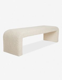 a white bench sitting on top of a white floor