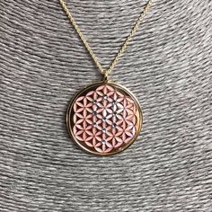 "Flower of Life in 24 carat gold on 925 silver, rose mother of pearl and crystals Sephiroth. Found in the most sacred places on Earth, its pattern evocates each form in nature as it is known. For the first time it appeared in the Temple of Osiris built in 1650 ac. Its shapes hidden the fruit of life and it presents a triangolar lattice form, with circle radii equal to their separation is called a seven overlapping circles grid. It contains six circles intersecting at a point, with a seventh circ Pink Gold Plated Necklace For Gift, Rose Gold Jewelry With Large Pendant As Gift, Pink Gold Pendant Necklace As A Gift, Pink Gold Round Necklace For Gift, Rose Gold Plated Jewelry With Large Pendant, Pink Gold Flower Pendant Necklace As Gift, Handmade Rose Gold Medallion Necklace, Rose Gold Plated Necklace With Large Pendant, Rose Gold Pendant Necklace Nickel Free