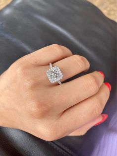 a woman's hand with a diamond ring on it