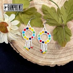 Beautiful Handmade Mexican Earrings , Mexican Shakira Earrings , Bohemian Boho earrings. 100% Handmade Handcraft by great Artisans in Mexico , These lovely Ear Wire earrings are extremely light and can be worn on all everyday occasions specially if you like colorful and fresh accessories. Aprox Size : 3 1/4 inches length & 1 3/8 inch wide Every piece is unique and color might change a little , depending on the screen device its been viewed on Aretes Mexicanos de Shakira , hecho a mano , Arte for Bohemian Rainbow Beaded Round Earrings, Colorful Bohemian Hoop Earrings For Festival, Bohemian Rainbow Round Beaded Earrings, White Bohemian Dangle Hoop Earrings, Bohemian Rainbow Dangle Hoop Earrings, Bohemian Multicolor Flower Earrings With Colorful Beads, Colorful Bohemian Round Beaded Earrings, Bohemian Multicolor Hoop Earrings With Dangling Beads, Bohemian Flower Drop Earrings With Colorful Beads