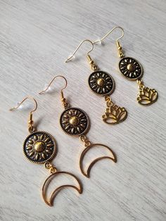 ❤ INFORMATION ❤  These beautiful minimalist earrings with golden coin mandala spacers and a gold crescent moon or lotus charm have golden plated hooks. The total length of the earring is 5,8-6.1 cm. The earrings are a nice colorful addition to any outfit, for a cheerful look for yourself or as an original gift for someone else! Sold per pair and you will receive the earring stoppers.  ❤ CARE ❤  I do not recommend swimming or showering with your jewelry on. When cleaning sterling silver jewelry, Bohemian Brass Earrings With Moon Charm, Gold Symbolic Moon Charm Earrings, Gold Symbolic Earrings With Moon Charm, Celestial Style Drop Earrings For Festivals, Symbolic Gold Earrings With Moon Charm, Gold Moon Phase Drop Earrings, Gold Moon-shaped Bohemian Jewelry, Bohemian Moon Shaped Gold Jewelry, Bohemian Moon-shaped Gold Jewelry