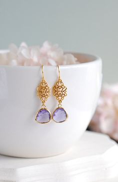 "Purple and Gold Earrings. Stunning faceted purple glass stones are suspended from beautiful matte gold ornate filigree connectors and gold plated hook ear wires. The total length of these earrings is approx. 1.8\" (46mm). Purple glass measures 12mmx 17mm If you prefer the glass stones in a different color, please feel free to contact me. ♥ Click here to see more earrings: www.etsy.com/shop/LeChaim?section_id=17655958 ♥ My shop: www.etsy.com/shop/LeChaim ♥ About LeChaim: www.etsy.com/shop/LeChai Jewelry Bridesmaid, Earrings Purple, Purple Earrings, Amethyst Purple, Drop Dangle Earrings, Purple Glass, Purple Wedding, Bridesmaid Earrings, Matte Gold