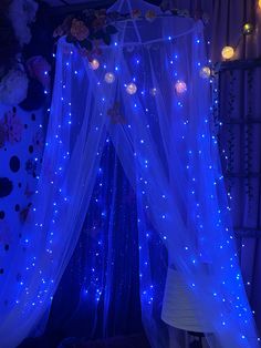 a canopy bed with blue lights on it