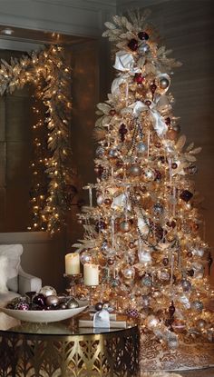 a gold christmas tree with ornaments and lights