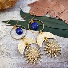 "Introducing: The \"Astraea\" collection PART 2. The Astraea features hammered metals, celestial elements and geometric shapes that form a gorgeous collection inspired by Greek goddess Astraea. Perfectly completed with deep blue lapis lazuli gemstone drops - Brass metal materials - 14k gold plated earring hooks - Gold plated brass Sun charms with tiny faux pearl inlay - Rubber ear nut backers included - 10mm lapis lazuli gemstone 2021©Wanderlust Hearts designs All Rights Reserved. WanderlustHear Goddess Astraea, Greek Goddess Jewelry, Celestial Elements, Sun Charm, Goddess Jewelry, Pearl Inlay, Hammered Brass, Celestial Jewelry, Moon Jewelry