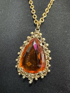 Vintage gold tone orange 5cm amber faceted Glass teardrop pendant necklace on 70cm chain Elegant Glass Drop Jewelry, Elegant Drop Glass Jewelry, Elegant Drop-shaped Glass Jewelry, Costume Jewelry Glass Party Jewelry, Orange Gemstone Dangle Jewelry, Dangle Long Metal Necklace As Gift, Metal Dangle Long Necklace For Gift, Metal Long Dangle Necklace As A Gift, Dangle Long Necklace As Gift