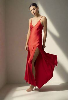 Make a bold statement in the Reseda Dress by Line and Dot! This stunning scarlet midi dress is crafted from luxurious satin-like material and features a playful design that accentuates your curves. The dress boasts a bold peek-a-bo detail in the skirt, with slits on both sides for a touch of feminine charm. It also features a deep V neck for added style. Pair it with strappy heels and an evening bag for your next special occasion! Composition and Fit: True to size Deep V neck Spaghetti Straps Do Dress Red, Playful Design, Strappy Heels, Deep V Neck, Deep V, Scarlet, Red Dress, Spaghetti Strap, Midi Skirt