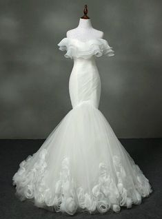 a white wedding dress on a mannequin