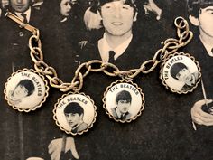 This vintage Beatles charm bracelet let is from 1964. It is a NEMS bracelet, so it is an authentic Beatles item licensed by their original management. The brace is a solid gold tone metal alloy, the face feel to be enameled. It measures 7 inches in length. As with all antiques, please understand this has been previously loved and some wear may be present. So please review pictures carefully and ask questions if there's something you would like to know more about. Please make sure you love it and Beatles Merchandise, Beatles Memorabilia, Charm Bracelet Vintage, Vintage Charm Bracelet, Vintage Pin Up, Bracelet Vintage, Vintage Magazines, Vintage Pins, Set Vintage