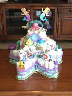 there is a cake made to look like it has mermaid decorations on top of it