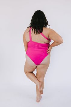 Beach-ready and beautiful in hot pink and red, our PLUS SIZE - Beach Bliss One Piece will have heads turning! With one shoulder-style and cheeky coverage, this one-piece swimsuit will make a splash! (And, of course, make you look FAB-ulous!) Details One-piece swimwear Removable padding Cheeky fit One shoulder Fully lined Sizing Approximate measurements: SIZE LENGTH BUST 1XL 29" 34” 2XL 30” 36" 3XL 31” 40” Fabric has stretch Model is 5’8” wearing 3XL Material 82% Polyester 18% SpandexHand wash co Pink One-shoulder Swimwear For Pool, One-shoulder Pink Swimwear For Beach, Plus Size One Piece Pink, Pink One-shoulder Swimwear, Pink One-shoulder Beachwear Swimwear, Pink One-piece Swimwear For Beach, Pink One-piece Swimwear For Pool, Pink Fitted One-piece Beachwear, Playful Pink One-piece Swimwear