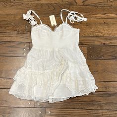 Iconic Ruffled Mini Dress In Sweet White Eyelet With An Adjustable Tie-Sleeve Detail From Shabby Chic Favorite Loveshackfancy. Perfect For Graduations, Sorority Rush Or Events, Date Night, Vacations, Or Brides At Bachelorette Parties, Engagement Parties, Engagement Photos, Showers, Courtyard Weddings, Rehearsal Dinners, Or Backyard Weddings! New With Tags. Size L. Fancy White Dress, Tiered Ruffle Mini Dress, Backyard Weddings, Ruffled Mini Dress, Sorority Rush, Engagement Parties, Lilac Dress, Ruffle Mini Dress, Pink Floral Dress