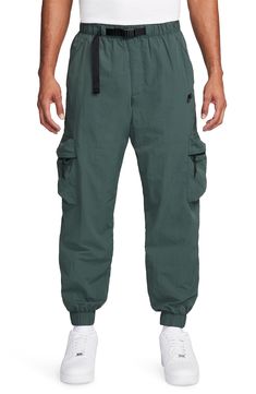 Lightweight, water-repellent nylon brings all-activity comfort to cargo pants that are cut with room to move and fitted with secure pockets for stowing your essentials. 29" inseam; 11" leg opening; 12 1/2" front rise; 16 1/2" back rise (size Medium) Elastic waist with integrated belt Front slant pockets; coin pocket; back zip pocket; cargo zip-patch pockets Elastic cuffs Water repellent Lined 100% nylon Machine wash, tumble dry Imported Sportswear Cargo Pants With Side Pockets For Outdoor Activities, Sportswear Cargo Pants With Side Pockets For Outdoor, Techwear Nylon Bottoms With Multiple Pockets, Sportswear Cargo Pants For Outdoor Activities, Sportswear Cargo Pants For Outdoor, Nike Functional Bottoms With Side Pockets, Nike Functional Cargo Pants With Pockets, Nike Functional Bottoms With Hip Pockets, Nike Cargo Pants For Outdoor