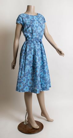 1950s Style Blue Summer Dress, Sleeveless Blue Dress For Vintage Fashion, 1950s Blue Summer Dress, Blue 1950s Style Summer Dress, Blue Retro Dress With Vintage Print, Blue Dresses With Vintage Print For Spring, Vintage Fashion Blue Lined Dresses, Spring Blue Vintage Fashion Dress, Blue A-line Mod Dress