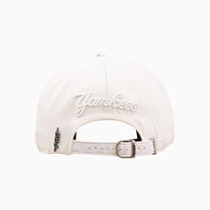 a white yankees hat with the word yankees written on it and a buckle at the front