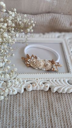 a close up of a flower on a bed with flowers in the background and a white frame around it