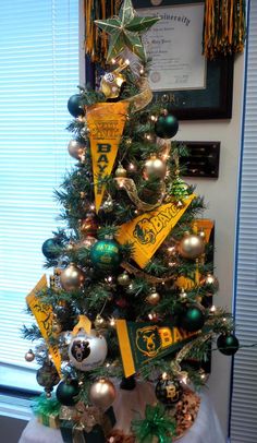 a christmas tree decorated with green and gold ornaments