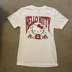 Sanrio Hello Kitty White/Mushroom Graphic T-Shirt Size Small. Brand New Without Tags. Casual Hello Kitty T-shirt For Streetwear, Hello Kitty Graphic Tee For Summer, Hello Kitty Summer Graphic Tee, Spring Hello Kitty Graphic Tee, White Short Sleeve Hello Kitty T-shirt, White Hello Kitty Print Fun T-shirt, Fun White Hello Kitty Print T-shirt, White Kawaii Hello Kitty T-shirt, Y2k Hello Kitty Print Crew Neck T-shirt