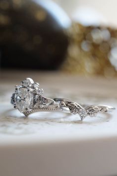 a diamond ring sitting on top of a table