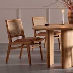 a wooden table with two chairs around it