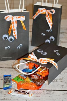 two halloween bags with candy and candies in them