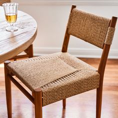 a wooden table and chair with a glass on it