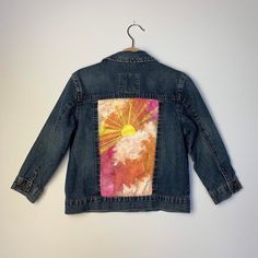 Sun rays and all the feels is what this Upcycled 4T denim jacket brings. I lovingly hand-painted jacket to create the ultimate one of a kind piece. This will be the first of many, because I'm obsessed with kids denim! Blue Denim Jacket With Custom Artwork For Spring, Spring Artistic Denim Jacket With Custom Artwork, Artistic Denim Jacket With Custom Artwork For Spring, Spring Casual Denim Jacket With Custom Artwork, Casual Cotton Denim Jacket With Custom Artwork, Casual Spring Denim Jacket With Custom Artwork, Casual Denim Jacket With Custom Artwork For Fall, Casual Hand Painted Cotton Outerwear, Custom Artwork Long Sleeve Cotton Denim Jacket