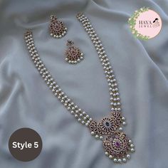 Embrace the timeless elegance of South Indian tradition with this stunning gold-plated haram necklace and earrings set. This exquisite piece features an intricate design adorned with sparkling CZ stones and delicate pearls, reminiscent of the grandeur of ancient temples. The long, layered necklace cascades down your chest, drawing attention to your neckline with its captivating beauty. Crafted with meticulous attention to detail, this set is perfect for: Bridal wear: Add an air of timeless sophistication to your wedding look with this breathtakingly beautiful set. Party wear: Make a statement at any special occasion with this eye-catching piece that is sure to turn heads. Cultural events: Immerse yourself in the rich heritage of South India with this authentic and elegant jewelry set. Feat Pearl Necklace Set Indian, Gold Perle Necklace, Gold Pearl Jewelry Necklace, Pearls Jewelry Indian, Long Necklace Designs, Pearl Haram, Chest Drawing, Long Necklace Indian, Diamond And Pearl Necklace