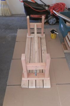 a wooden chair sitting on top of a cardboard box