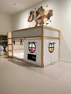 a bunk bed with an airplane theme on the top and two windows in the bottom