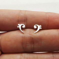 "Introducing Bass Clef Music Stud Earrings. Base Material: 925 Sterling Silver  Size: 6mm X 6mm (Approximately) Metal Stamped: 925 Themes: Music Style: Push Back Stud Thickness: 1.5mm If you need the item urgently, please contact us for Express Mail. There are extra cost for Express service. You'll receive Order Shipped Email from us when your item is completed and shipped. SPECIAL ANNOUNCEMENT  1. Please visit https://www.etsy.com/shop/yhtanaff for more designs. 2. Subscribe our newsletter to r Music Themed Jewelry, Happy Classroom, Music Note Jewelry, Music Note Ring, Music Teacher Gift, Bass Clef, Music Teacher Gifts, Musical Jewelry, Music Jewelry