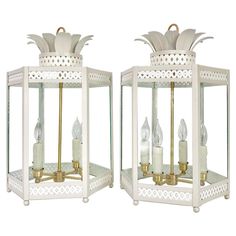 two white lanterns with pineapples on them